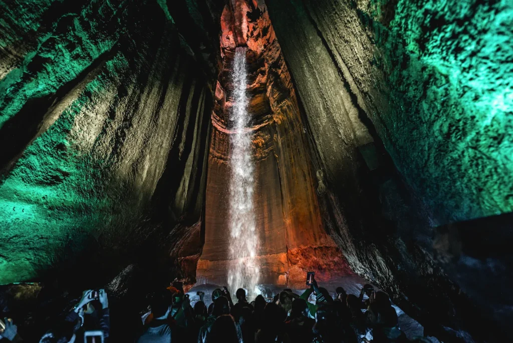 Ruby Falls underground waterfall lit with green and orange lights