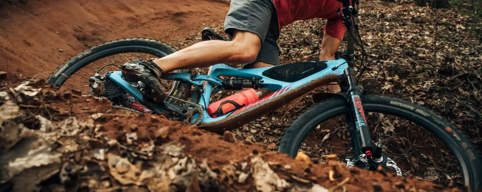 Close up shot of a biker riding a mountain bike on a steep curve