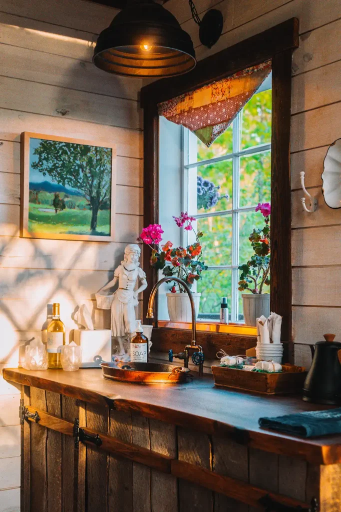 Sunlight flowing into a window over a kitchen sink in a treehouse