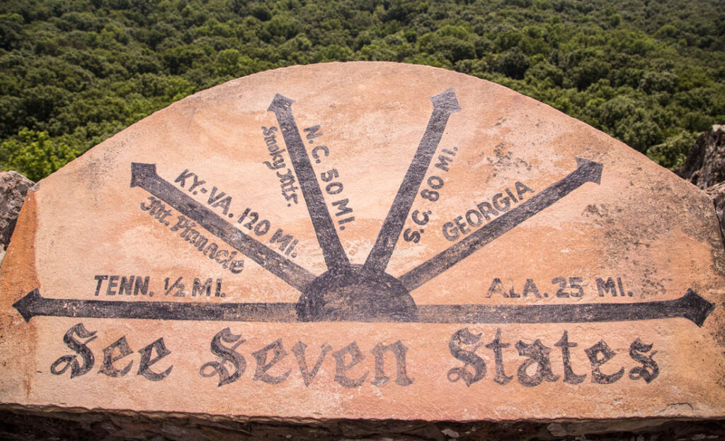 directional marker engraved into stone, pointing to seven U.S. states