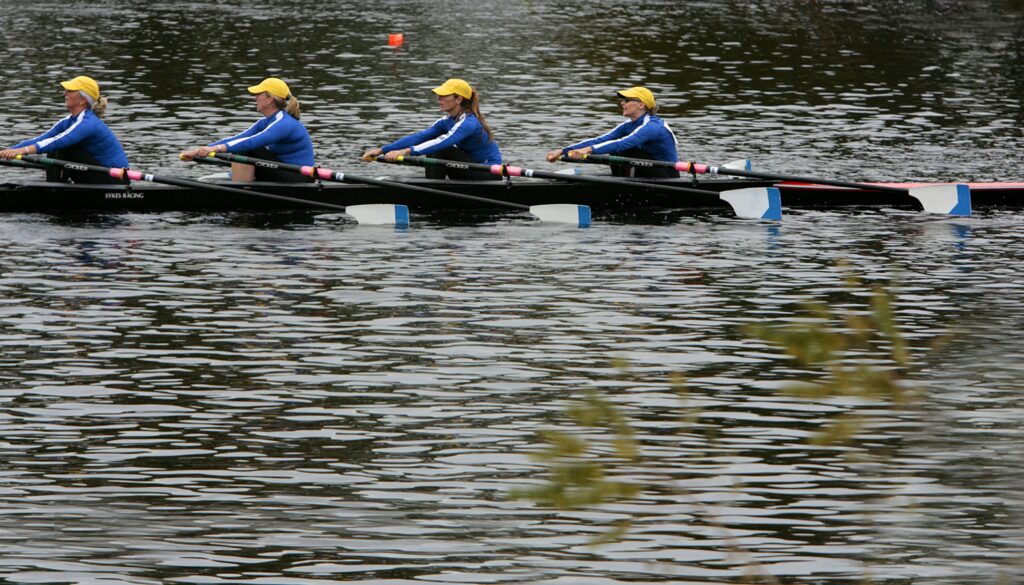 A group rowing a regatta along the river 