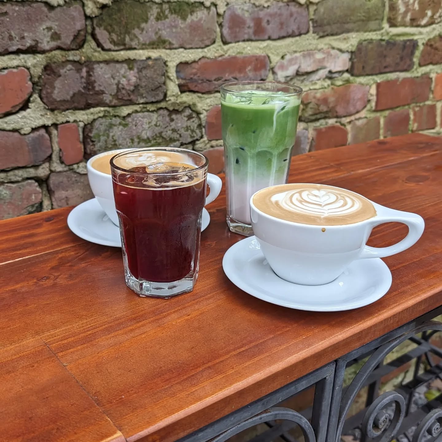 assortment of coffee and tea beverages on a wooden counter