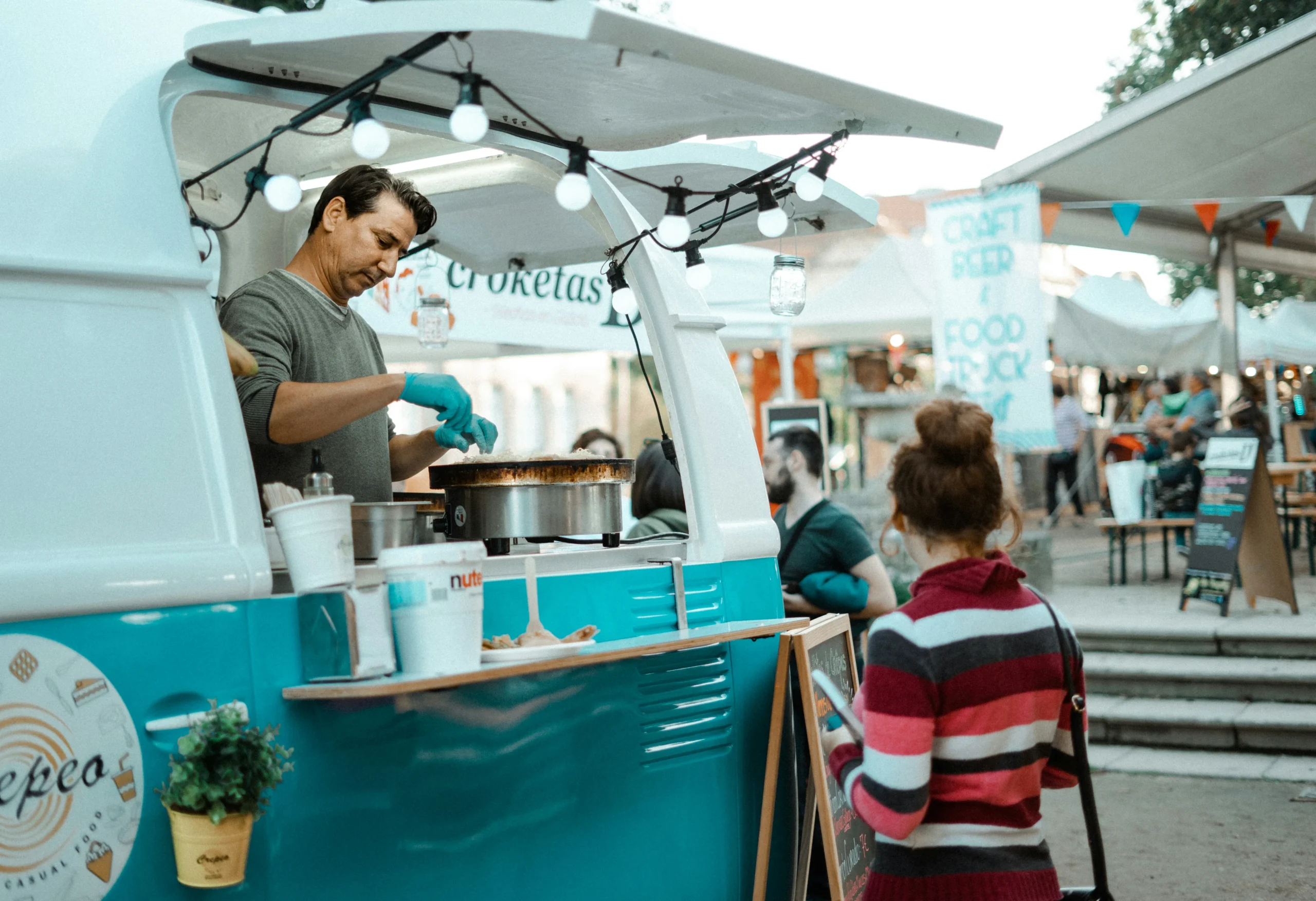 A women standing and ordering at a food truck
