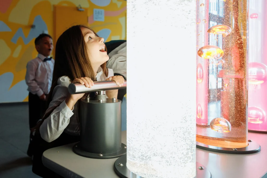 Young girl playing at an interactive exhibit in a museum