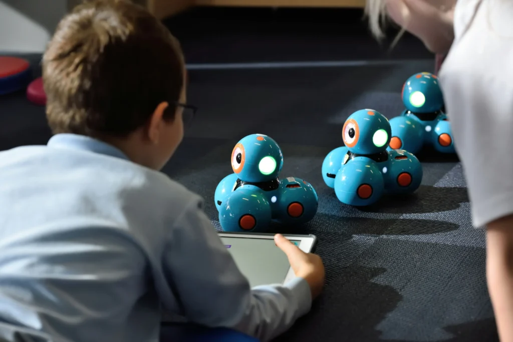 A young buy playing with robotics through a STEAM program at Creative Discovery Museum