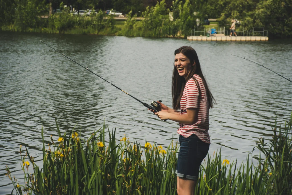 A girl smiling while fishing along the Ocoee river