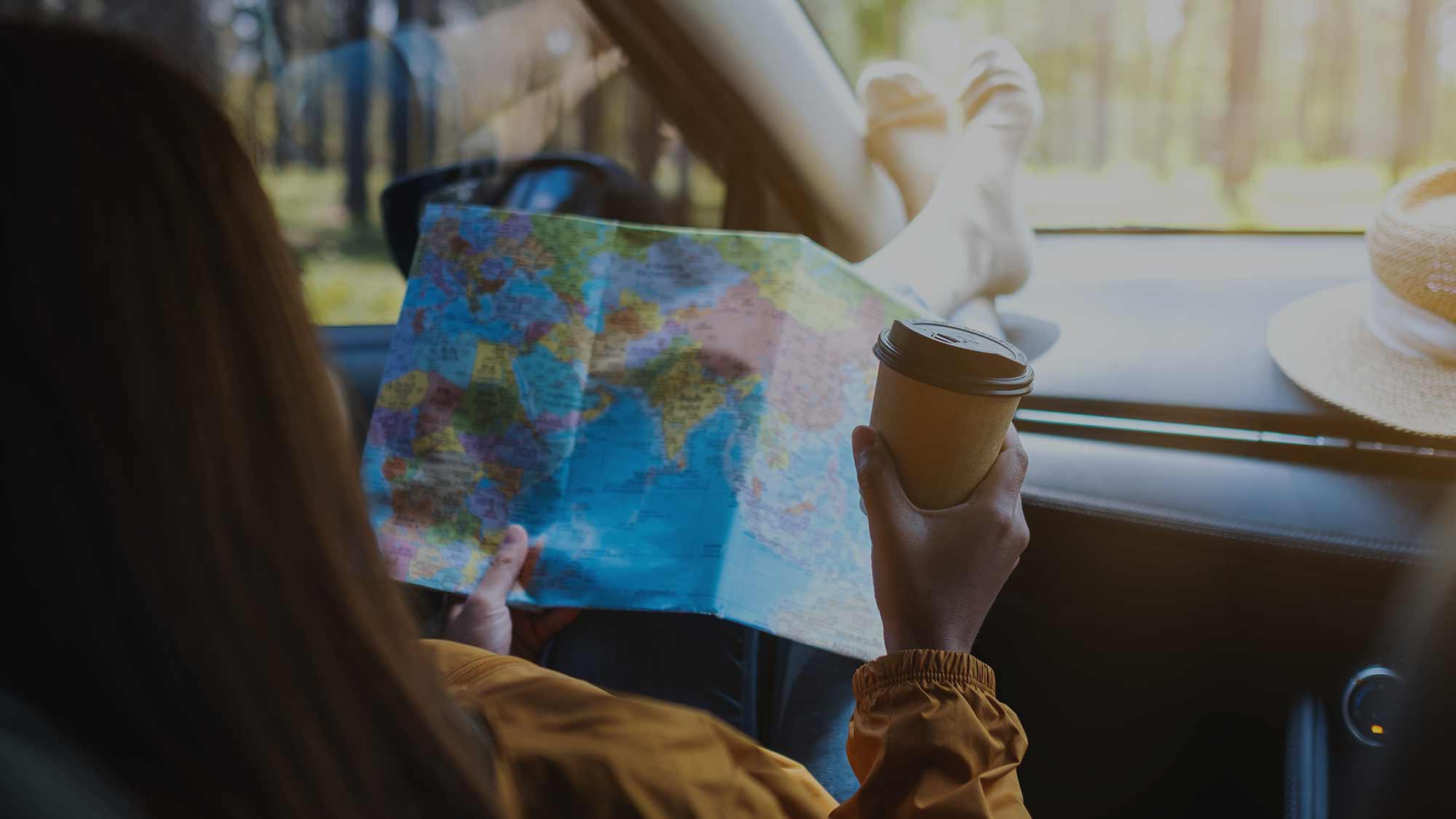 A young woman reading a paper map outdoors, looking for directions to Quail Run Farm.