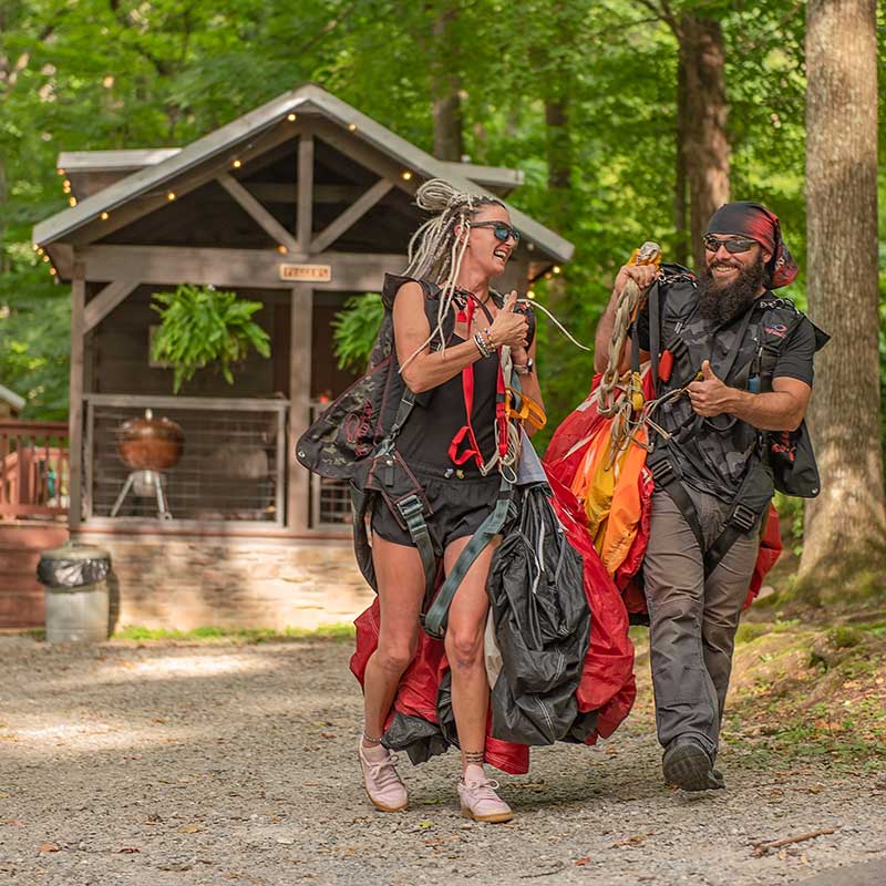 two skydivers walking away from a tiny cabin in chattanooga