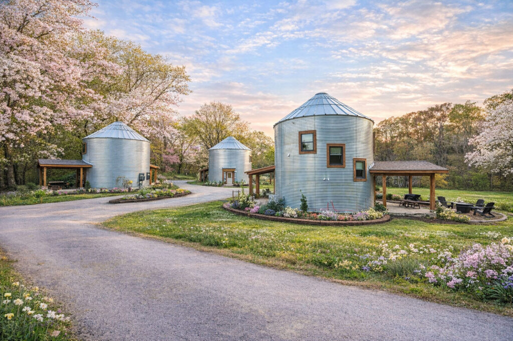 Converted grain silo stays at Quail Run Farm in Chattanooga, Tennessee, surrounded by spring blooms, landscaped gardens, and peaceful countryside views.
