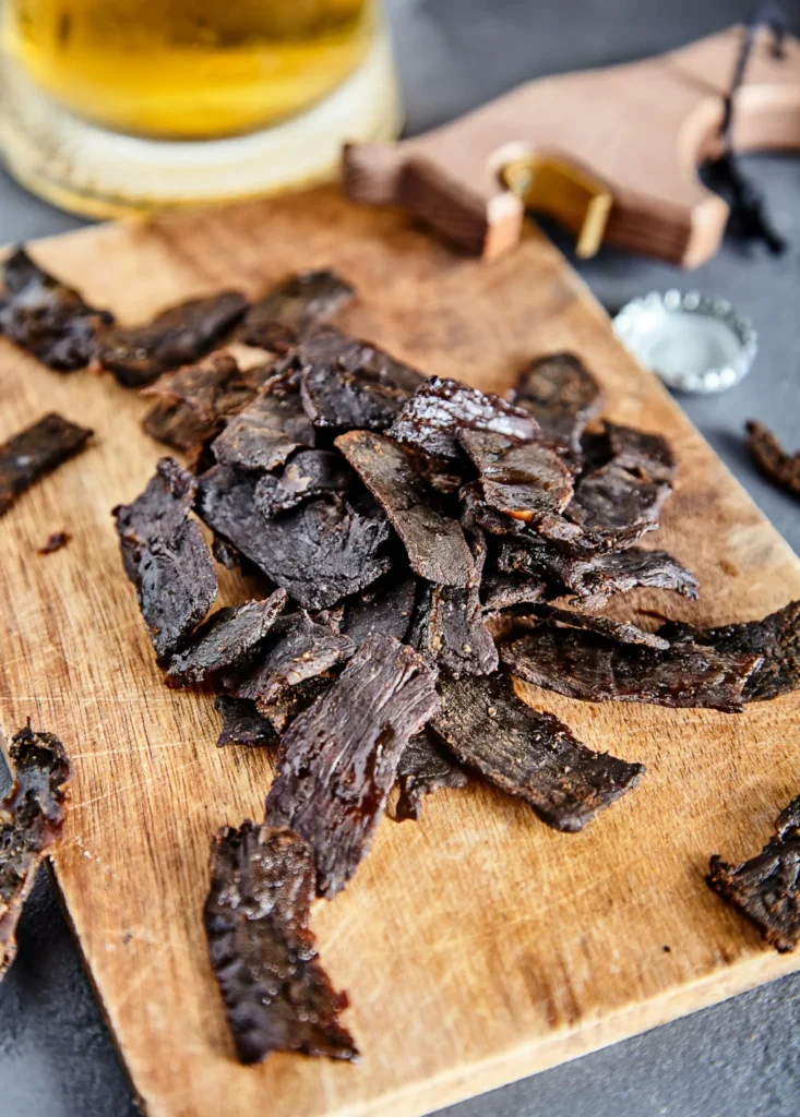 Beef jerky sitting on a wooden table