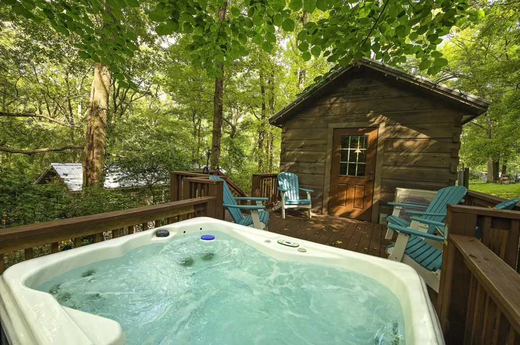 Private outdoor hot tub on a wooded deck at a tiny cabin in Wauhatchie Woodlands near Chattanooga